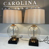 Pair of Clear Globe Lamps with Black and Gold Bases