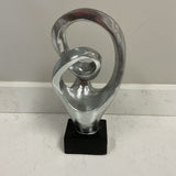 Silver Sculpture On Black Stand